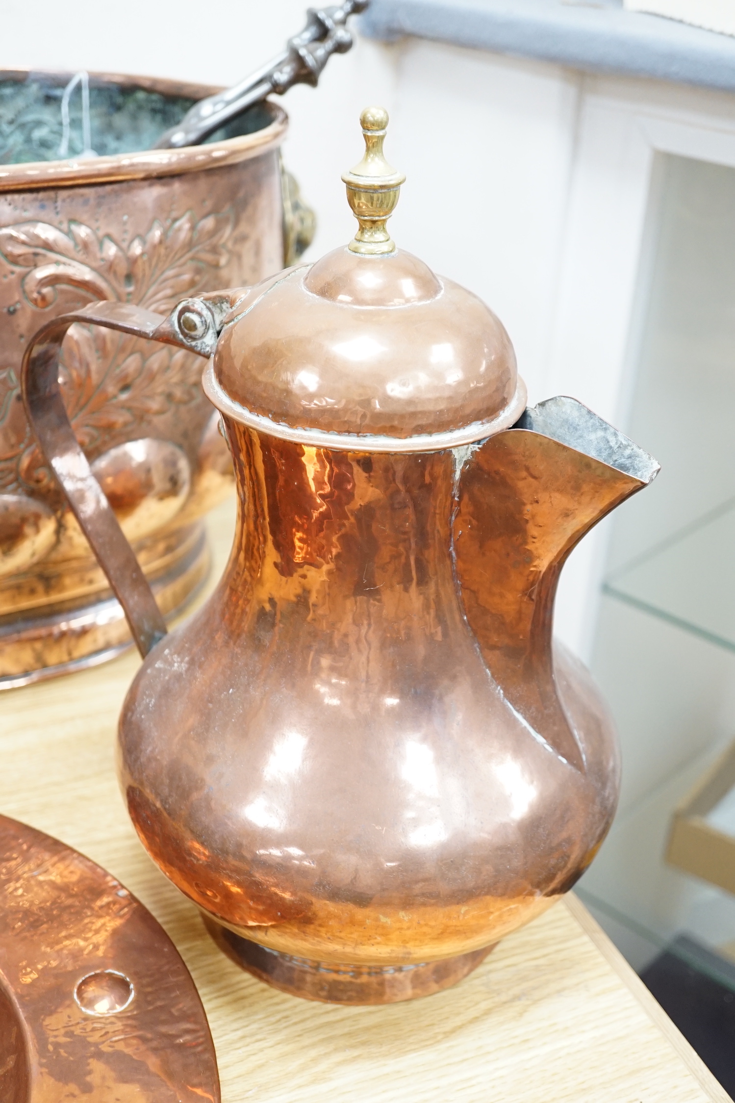 An 18th century Dutch beaten copper planter of elongated form with lion mask handles, beaten ship decoration and heavy gadrooning, 62cm long (Provenance Bonhams Chester 31/10/03). A large 19th century copper jug, baluste